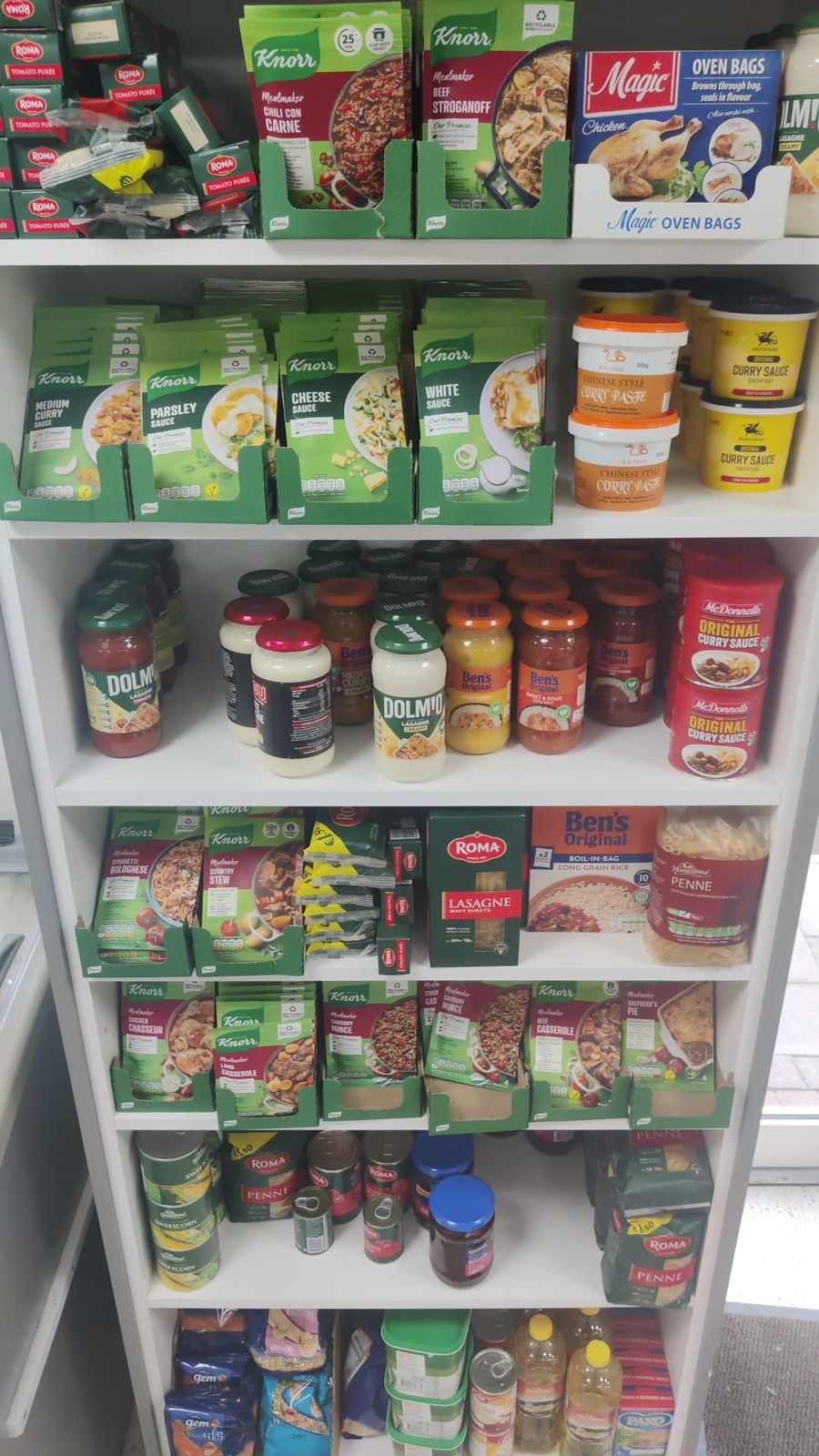 Store cupboard shelves of sauces, meal mixes, pasta and tins